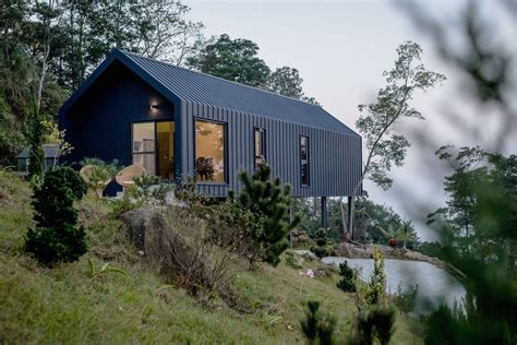 black metal a frame house on stilts|buildings with black stilts.